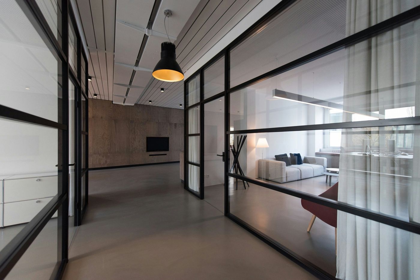 Modern office with glazed partitions and a meeting area